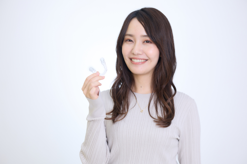 マウスピース矯正をする笑顔の女性