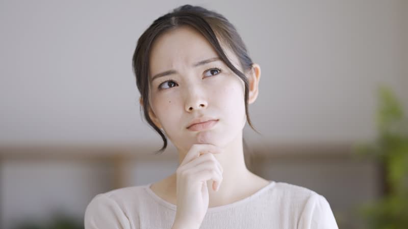 前歯のインプラント治療は難しいのか考える女性